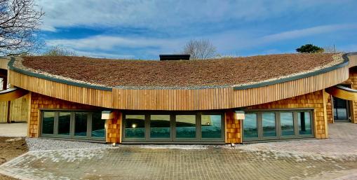 Earth Lab facility showcasing natural building materials and wildflower roof